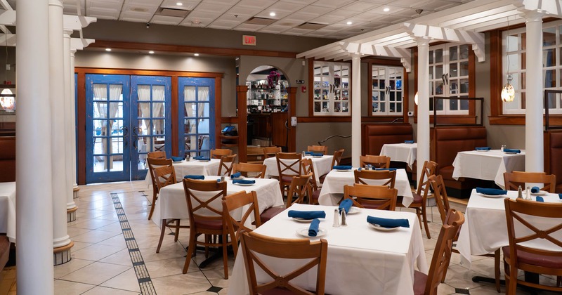 Interior, dining area, set up tables with chairs, elevated seating booths in the back