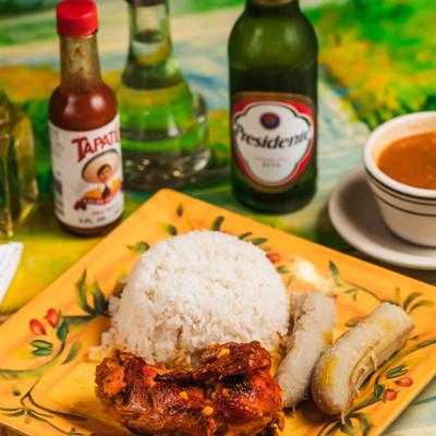 Chicken breast in garlic sauce served with boiled plantains and rice.