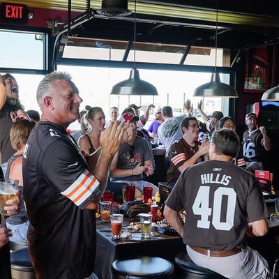 Smiling fans clapping, guy in a willis 40 jersey