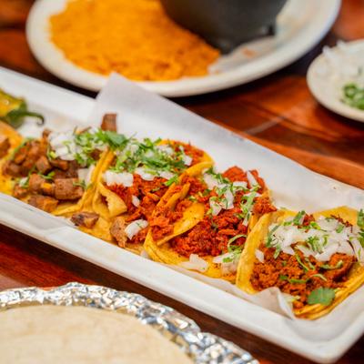 Marinated chicken tacos with cilantro and onion.