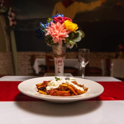 Pasta topped with meat sauce and ricotta cheese.