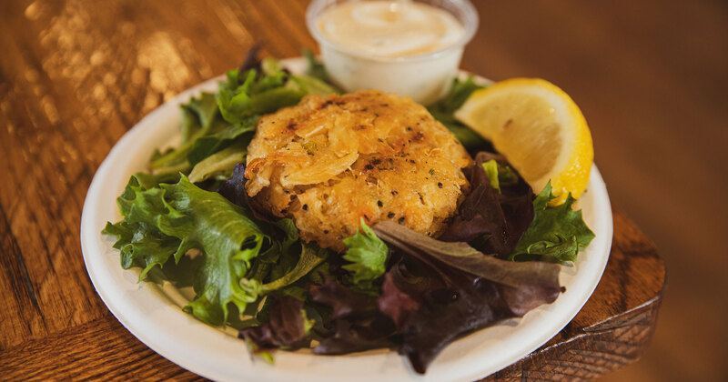 Grilled fish, white dip, lemon, green salad