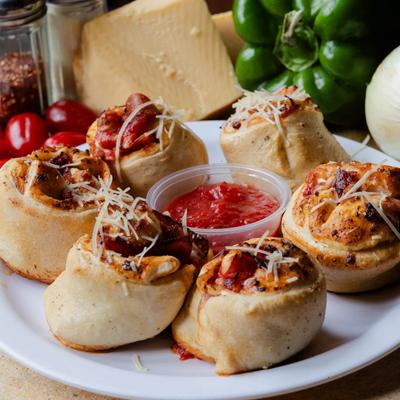 Pizza rolls with cheese and marinara dipping sauce.