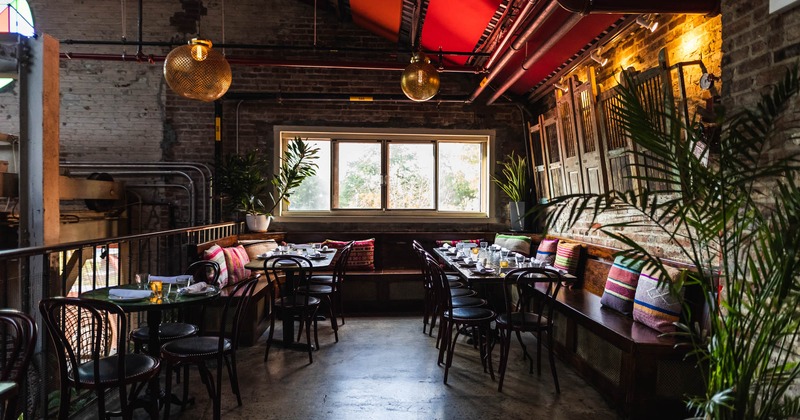 Interior, lined up tables ready for guests, booths