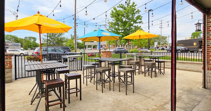 Patio with high tables and stools and parasols