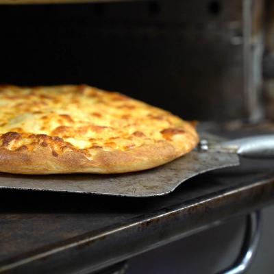 Cheese pizza in the oven.