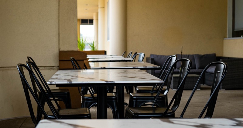 Interior, lined up tables and chairs ready for guests