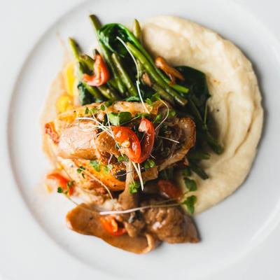 Seasoned chicken served over mashed potatoes, green beans, and mushrooms.