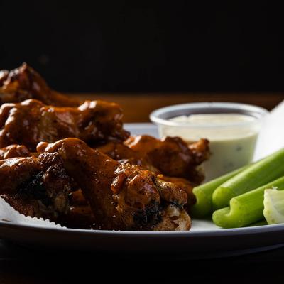 BBQ chicken wings, with celery, and blue cheese dressing.