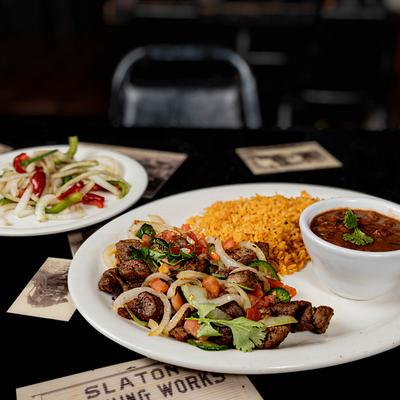 Steak chunks, with grilled veggies, rice, beans, and a side salad.