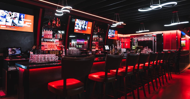 Bar area, neatly lined up bar stools