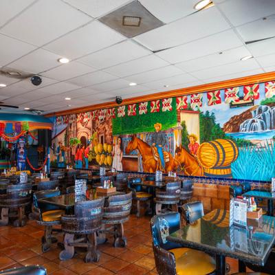 The interior of the restaurant, tables and chairs.