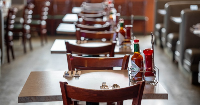 Interior, tables and chairs all lined up, ready for guests