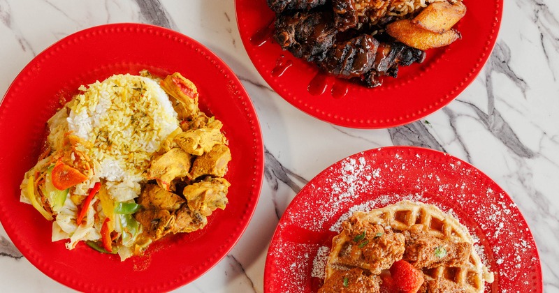 Jerk chicken with rice, curry chicken with rice and vegetables, chicken and waffles