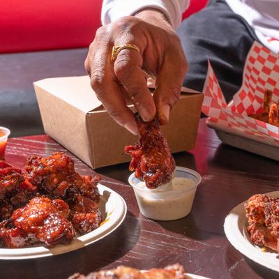 BBQ chicken wing dipped in sauce.