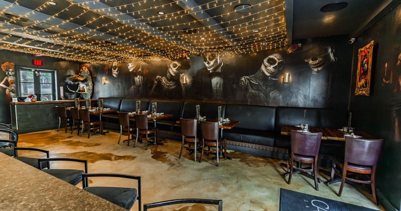 Interior first floor seating area, long leather sheeted banquette bench with wooden tables