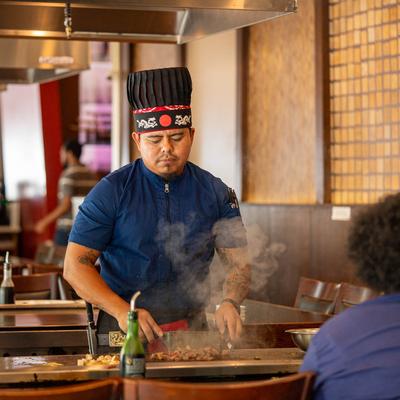 Chef preparing foo in the teppanyaki style.