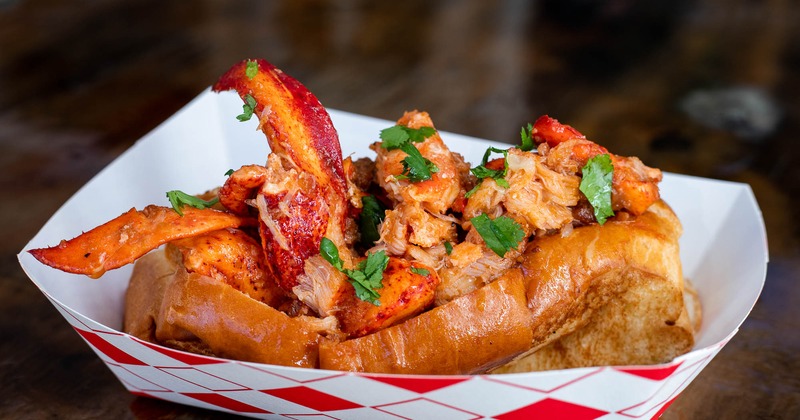 Lobster roll topped with a touch of cilantro