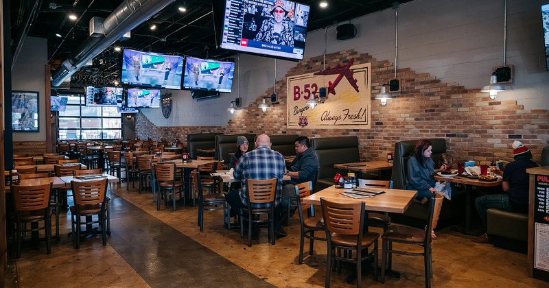 Interior space, dining tables and booths, guests enjoy their food