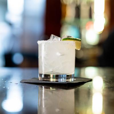 A classic Margarita cocktail with ice, salt rim, and lime garnish.