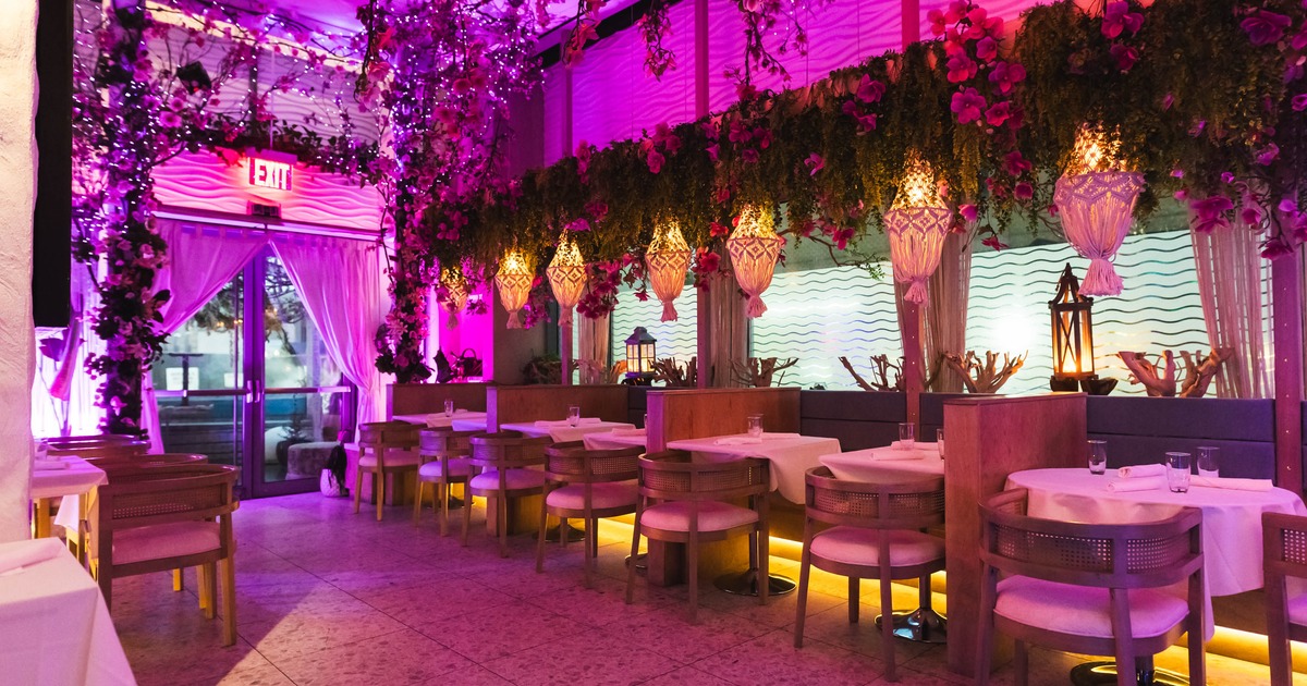Interior dining area with floral decorations and hanging lanterns