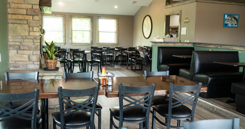 Interior, dining area, chairs and tables ready for guests, windows, long table setup