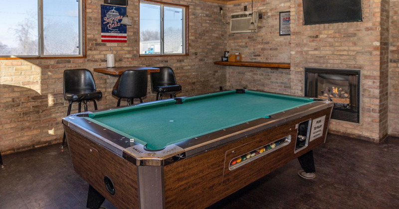 Interior, a pool table, wall -mounted table with chairs and a wall tv