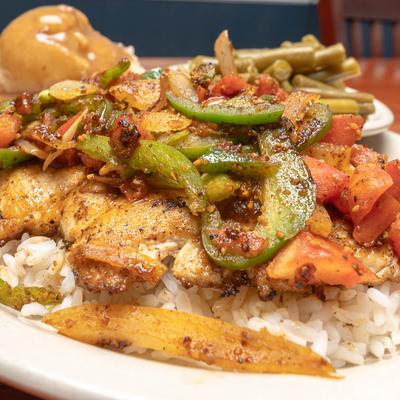 Cajun Chicken Breast Over Rice, with onions, peppers, and tomatoes.