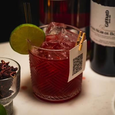 Red cocktail drink on the rocks.