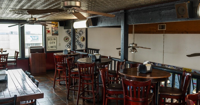 Interior, seating area with bar stools and tables