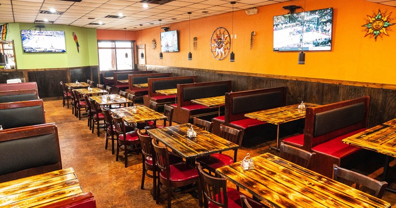 Interior, dining area with tables and tv sets