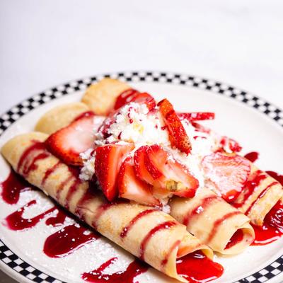 Crepes with strawberries and whipped cream.