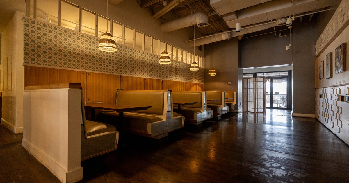 A restaurant interior with booth seating