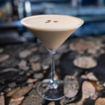Espresso Martini garnished with three coffee beans.