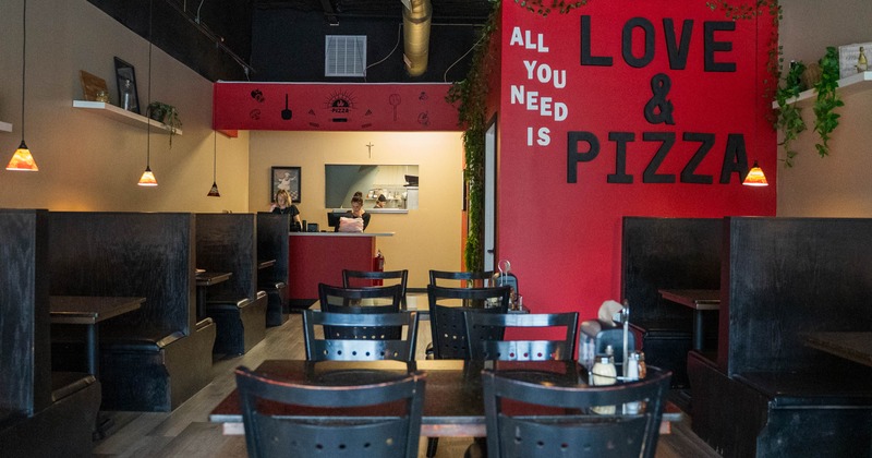 Interior with both booth and table seating, signage and wall decorations