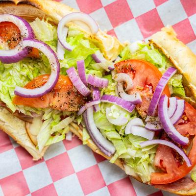 Sub with ham, turkey, pepperoni, lettuce, tomato, and onion.