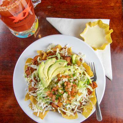 Nachos dish with juice on side, top view