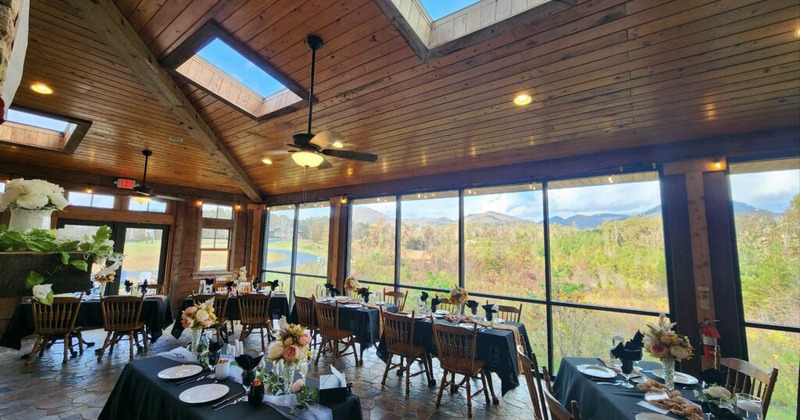 Interior, dining area, tables and chairs ready for guests, large window area, river view
