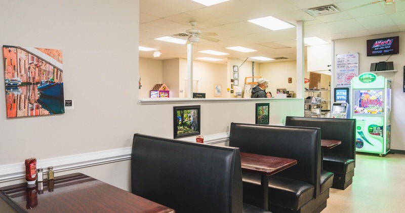 Interior of a restaurant with booths, a photo on the wall