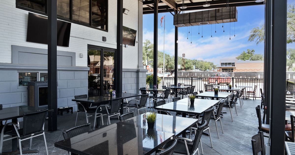 Covered patio with tables and chairs lined up
