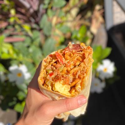 Customer holding a burrito.