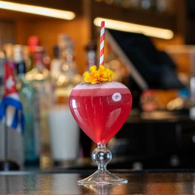 Cocktail served in hart shaped glass.