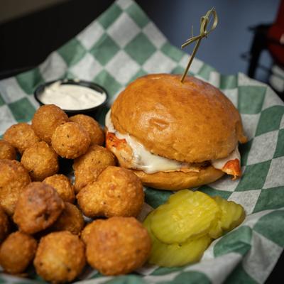 Grilled Buffalo Chicken Sandwich with battered mushrooms on the side.