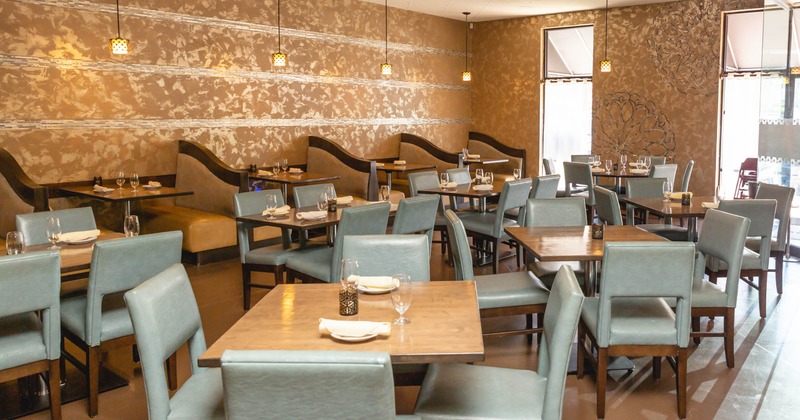 Interior, light blue chairs and wooden tables, booths