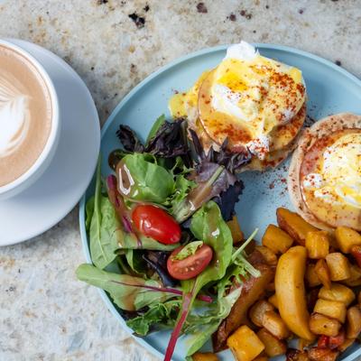 Eggs Benedict, wit salad and roasted potatoes.