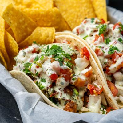 Baja fish tacos served with tortilla chips on the side.