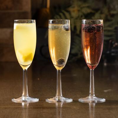 Pineapple, Mango, and Cranberry mimosa, lined up on a table.