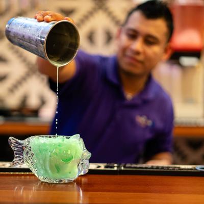 A bartender pouring Mi Vera Cruz cocktail.
