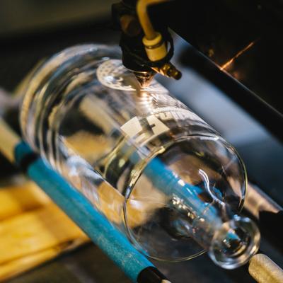 A machine stamping a bottle.