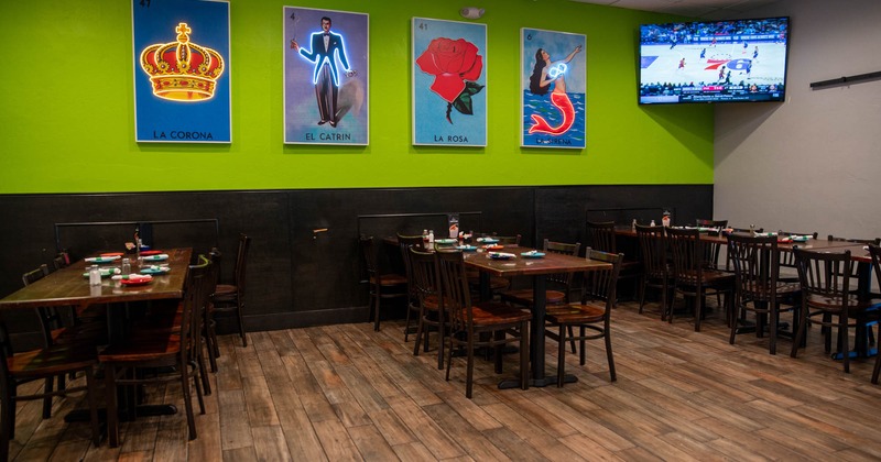 Interior, dining area, tables with chairs ready for guests, neon posters on the wall